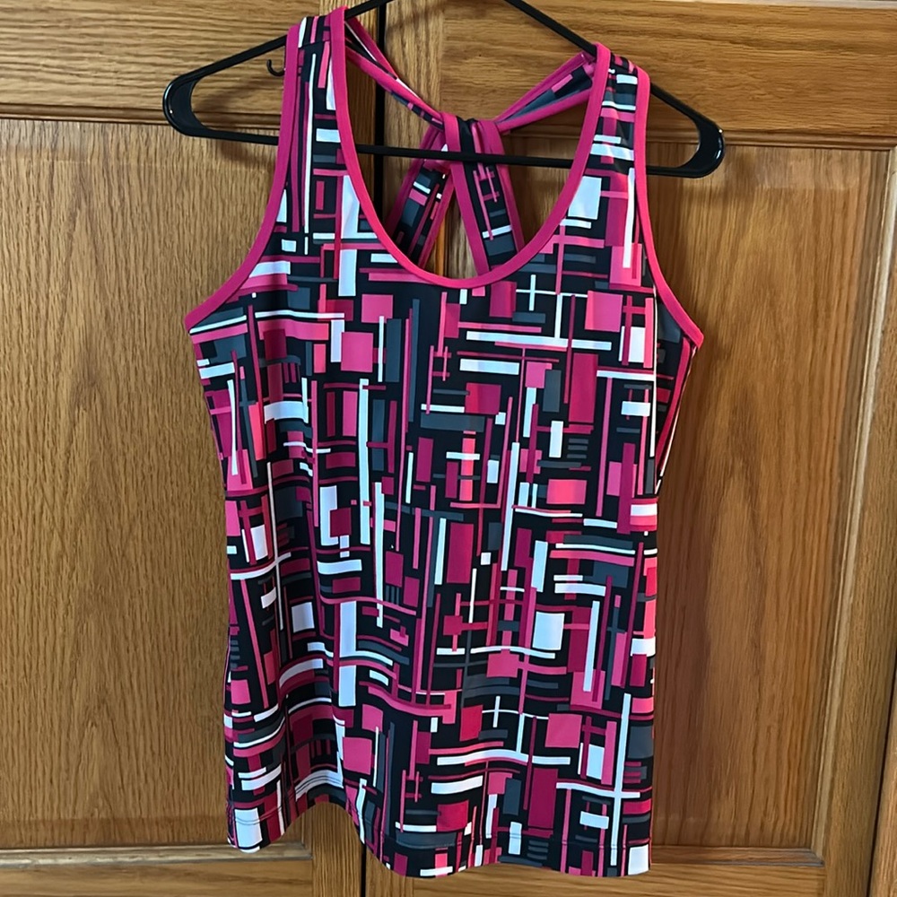 Women’s athletic top. Lined shelf bra. Stretchy. Back strap is a twisted T.